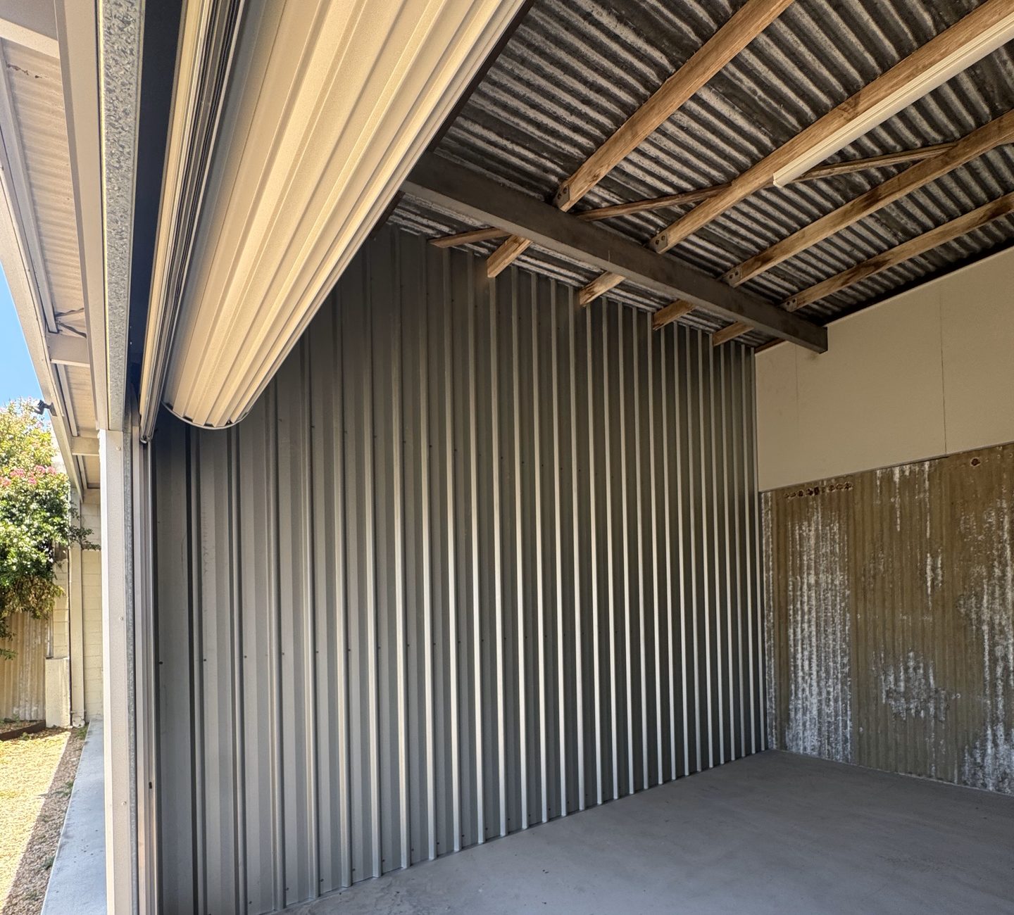 Interior of a drive-up self storage shed at French Street Centre in Pimlico, Townsville, showing the corrugated iron walls and concrete floor